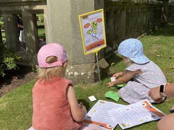 People engaging with the Ecosystem Invaders campaign stand, participating in the invasive species hunt activity