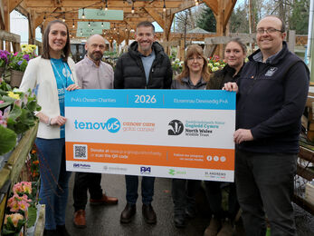 Woodworks team presenting Charity of the Year in the form of a large board including NWWT logo