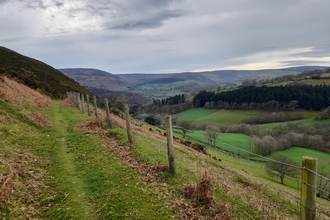 The Dee valley, a patchwork of farm fields and trees along the sloping hills that line the valley as it snakes through the landscape.