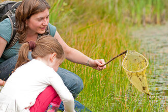 Mother and daughter pond dipping 