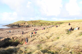 Beach cleaners at Porth Trecastell