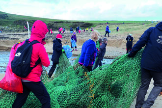Fishing net being removed at Plast Off beach clean event