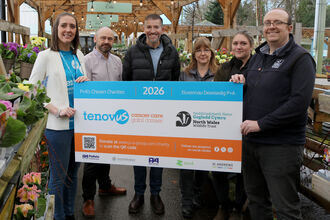 Woodworks team presenting Charity of the Year in the form of a large board including NWWT logo
