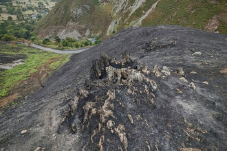 Wildfire site, landscape shot of mountains with sea on the horizon