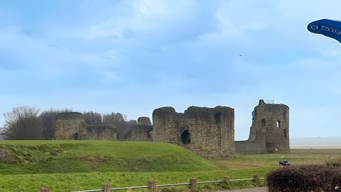 Blue sky Flint castle with whale tail sculpture