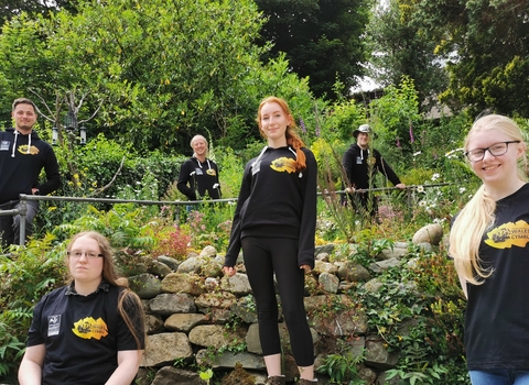 Stand for Nature Wales members standing in garden in branded kit